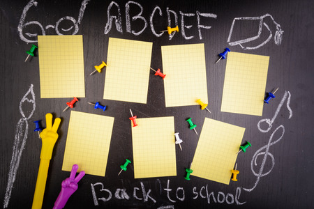 Weekly schedule with pins and two pens on black table. Back to school concept