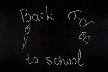 Back to school concept. White chalk on blackboard with copy spaceの写真素材