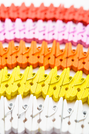 Colorful wooden small pegs lines with selective focus vertical shotの写真素材