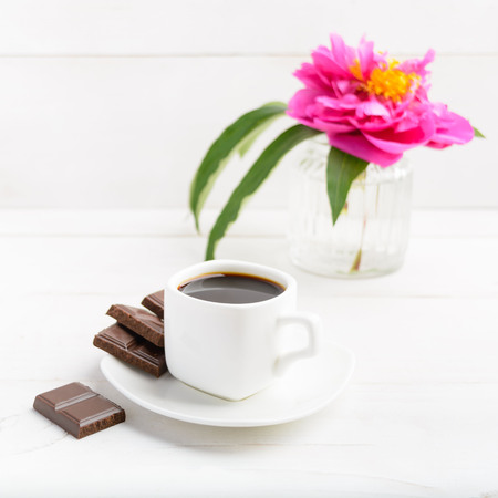 Morning coffee and flower over white wooden table with copy space, square shotの写真素材