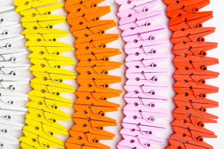 A variety of colorful wooden pins over white background top viewの写真素材