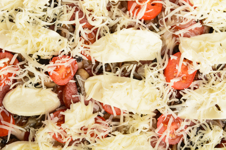 Uncooked homemade pizza background, closeup top viewの写真素材