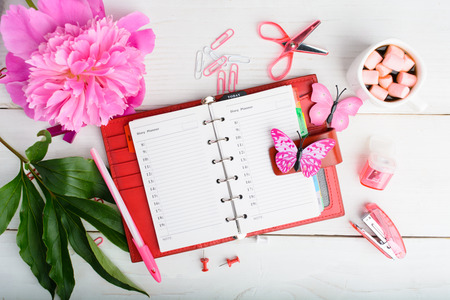 Woman organization plan with notebook, hot chocolate and flowerの写真素材