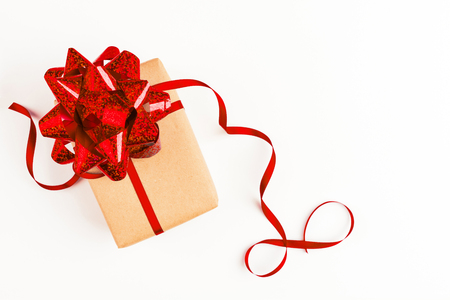 Festive gift with red bow on white background, overhead viewの写真素材