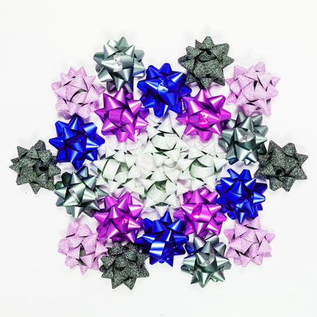 Colored bows on white, top view, square shot