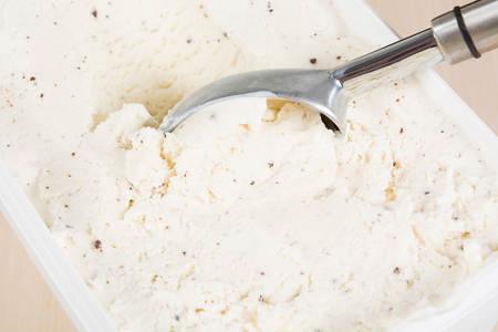 Chocolate ice cream with chocolate crumb with metal spoon, closeup viewの写真素材