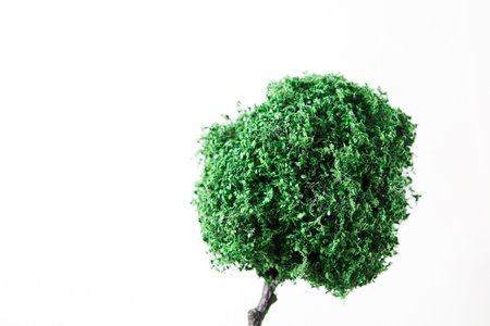 Unreal small green miniature of tree for design on white backgroundの写真素材