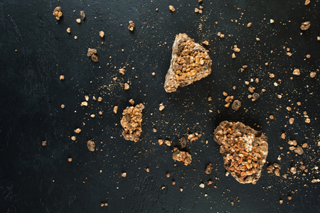 Three pieces of chocolate mass on black background with copy space, flat lay