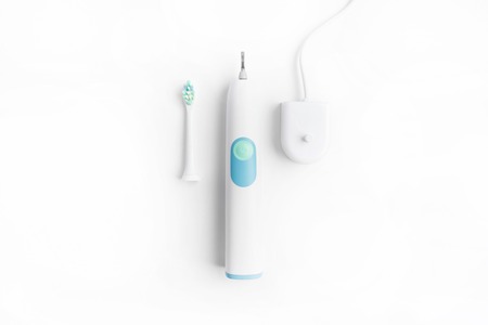 Three part of electric toothbrush in center on white background with top view, flat lay style with copy spaceの写真素材
