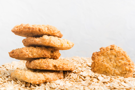 Homemade cookies of oat over the dry oatmeal on white background with copy spaceの写真素材