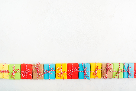 Colorful gifts with Cristmas rope over white background, flat lay style with copy spaceの写真素材
