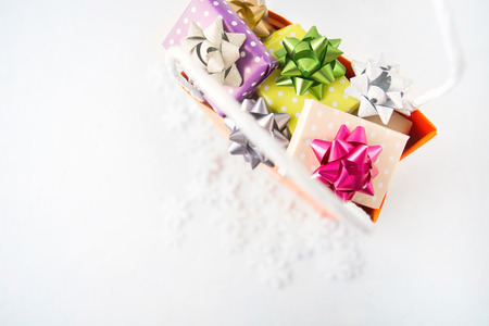 Christmas gifts in shopping paper bag, flat lay on white background with copy spaceの写真素材