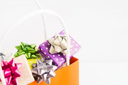 Christmas shopping bag with colorful gifts, closeup view, selective focusの写真素材