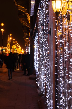 Christmas decoration with garland in focus and night city, selective focusの写真素材