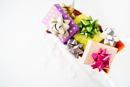 Holiday shopping concept with colorful gifts in the paper bag, flat lay style with copy spaceの写真素材