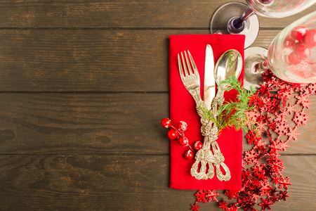 Table setting for winter holiday on wooden background with copy space, flat lay styleの写真素材