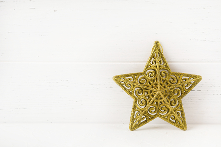 Christmas star on white wooden background with copy space, New Year decorationの写真素材