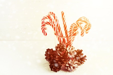 Toned Christmas candy canes with pine cones with copy spaceの写真素材