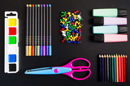 Different school accessories over blackboard background, flat layの写真素材