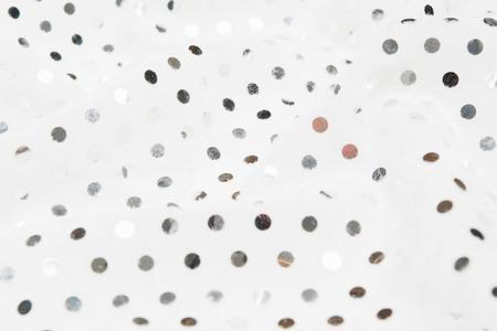Closeup view of fabric textile material with silver sequins. Glamour metal glitter backdrop. Selective focusの写真素材