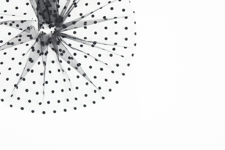 Elegant black textile round composition with black circles. Sewing concept. Tulle fabric material on white background with copy space. Flat lay style. Top view. Retro style decoration for clothesの写真素材