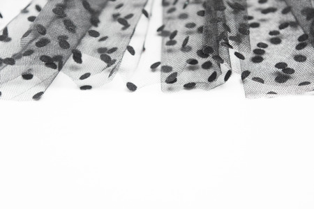 Black drapery fabric textile tulle material background with selective focus. Abstract design decoration for card on white background with copy spaceの写真素材