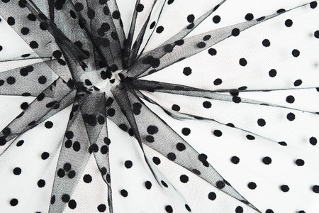 Abstract composition of black tulle material isolated on white background. Circle shape of tulle fabric with copy space. Sewing conceptの写真素材