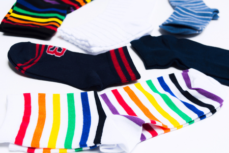 Different material textile socks for legs on white background. Clothes for warm weather. Shopping...