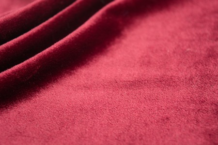 Wavy material, red velvet background for holiday. Copy space. Selective focusの写真素材