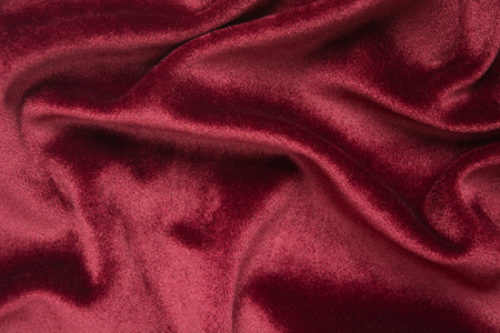 Red velvet texture abstract background. Fashion textile backdrop Holiday design material with waves. Flat layの写真素材