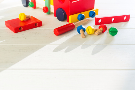 Wooden constructor with screwdriver and screw for early children's education. Copy space. Selective focus. Car blocksの写真素材