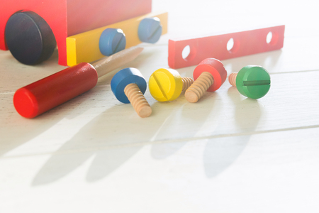 Car wooden constructor for preschool education. Children's activity with screwdriver and screws. Baby skills conceptの写真素材