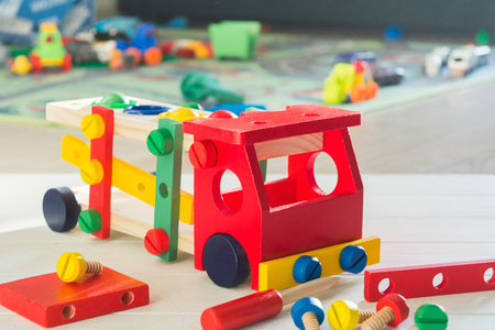 Toy wooden car constructor in children's room. Selective focus. Preschool education concept with colorful details.の写真素材