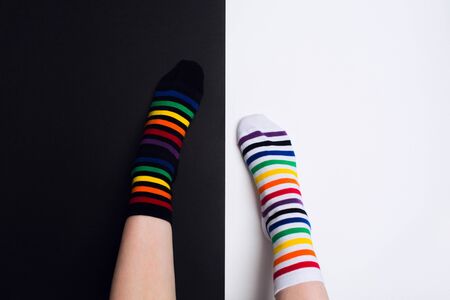 Two nagative legs with white and black striped colorful socks with negative background with copy space. Flat layの写真素材