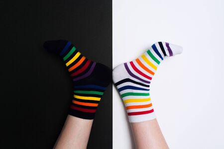 Funny legs with white and black striped new clean colorful textile socks. Fashion accessories for feet with negative background with copy space. Flat layの写真素材