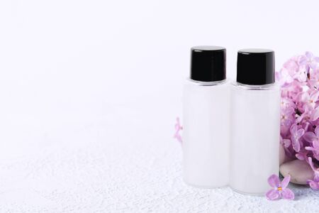 Hotel version of products for body. Shampoo, conditioner or shower gel with natural lilac aroma with copy space. Soft focus. Mockupの写真素材