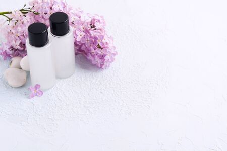 Mockup of spa with two products for bath with natural lilac. Shampoo or shower gel. Beauty concept. Copy space. Selective focusの写真素材