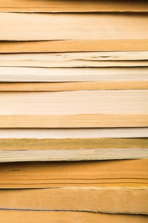 Vintage books in stack. Library with many old books background. Vertical shot. Many informationの写真素材