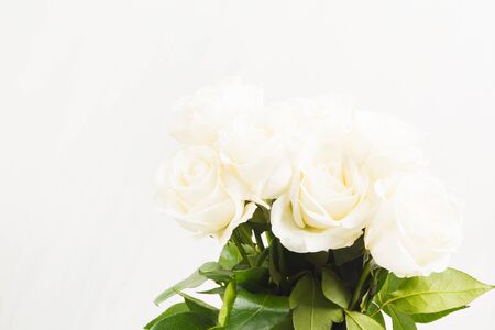 Bouquet of white roses on white background with copy space. Valentine's day, wedding or romantic conceptの写真素材