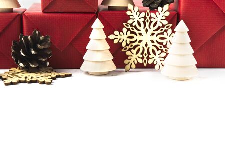Christmas background with eco natural decoration over white wooden table. Wooden fir trees, snowflakes and pine cone. Copy spaceの写真素材