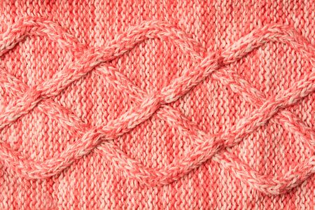 Red sweater textured background with pattern. Textile woolen clothes for winter. Horizontal. Flat layの写真素材