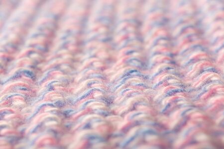 Wool textured pattern background with pink and blue threads. Soft focus. Fashion