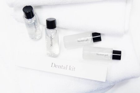 Shower kit with shampoo, gel, dental set and white towels for hotelの写真素材