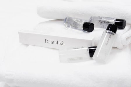 Hygiene set with shampoo and shower gel in plastic bottle with white towels. Small template of body care for hotels. Travel kit. Spa conceptの写真素材