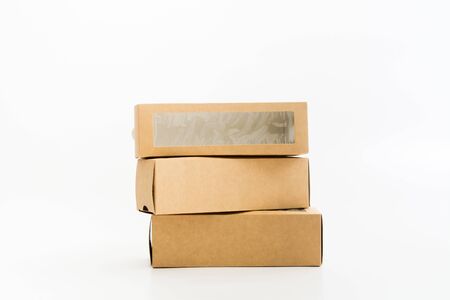 Stack of paper boxes with transparent plastic window on white background. Mockup design. Boxes for...