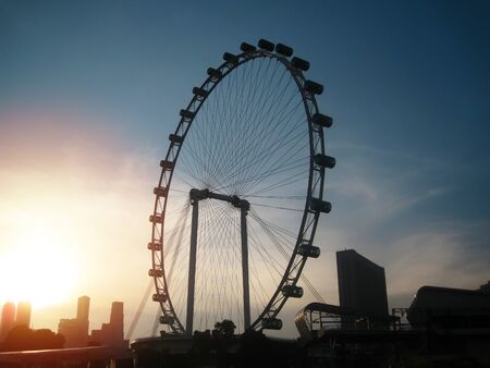 Big ferris wheel silhouette with beautiful sunset. Singapore attractionの写真素材