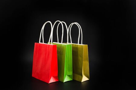 Paper shopping bags on black background with copy space. Empty package for sale conceptの写真素材