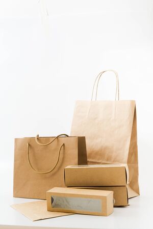 Recyclable paper bags and boxes on white background. Shopping concept. Zero wasteの写真素材