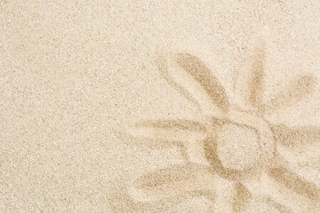 Picture of sun with hand on sand. Summer holiday texture design backgroundの写真素材