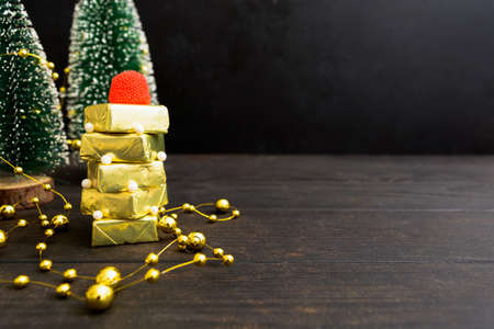 New Year Christmas fir tree of candies in golden cover with jelly candy on topの写真素材